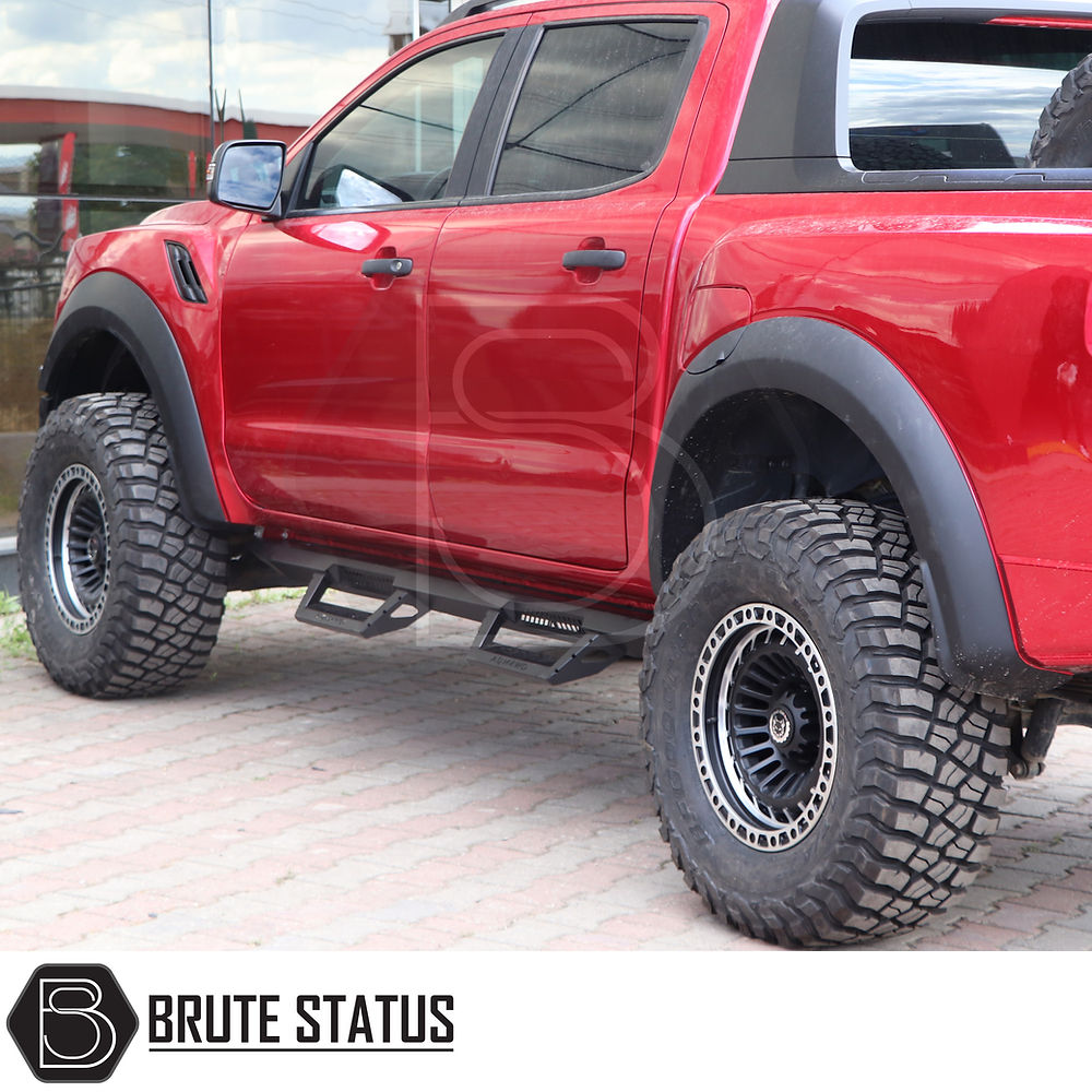 Toyota Hilux 2015+ Heavy Duty T32 Steel Side Steps, shown mounted on a red truck, emphasizing robust and high-quality design for enhanced vehicle protection.