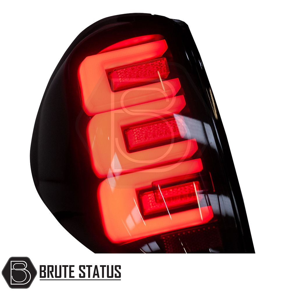 Mitsubishi L200 MK4 2006-14 LED Tail Lights, featuring clear lenses, white accents, and black backing, designed for easy installation and enhanced truck styling.