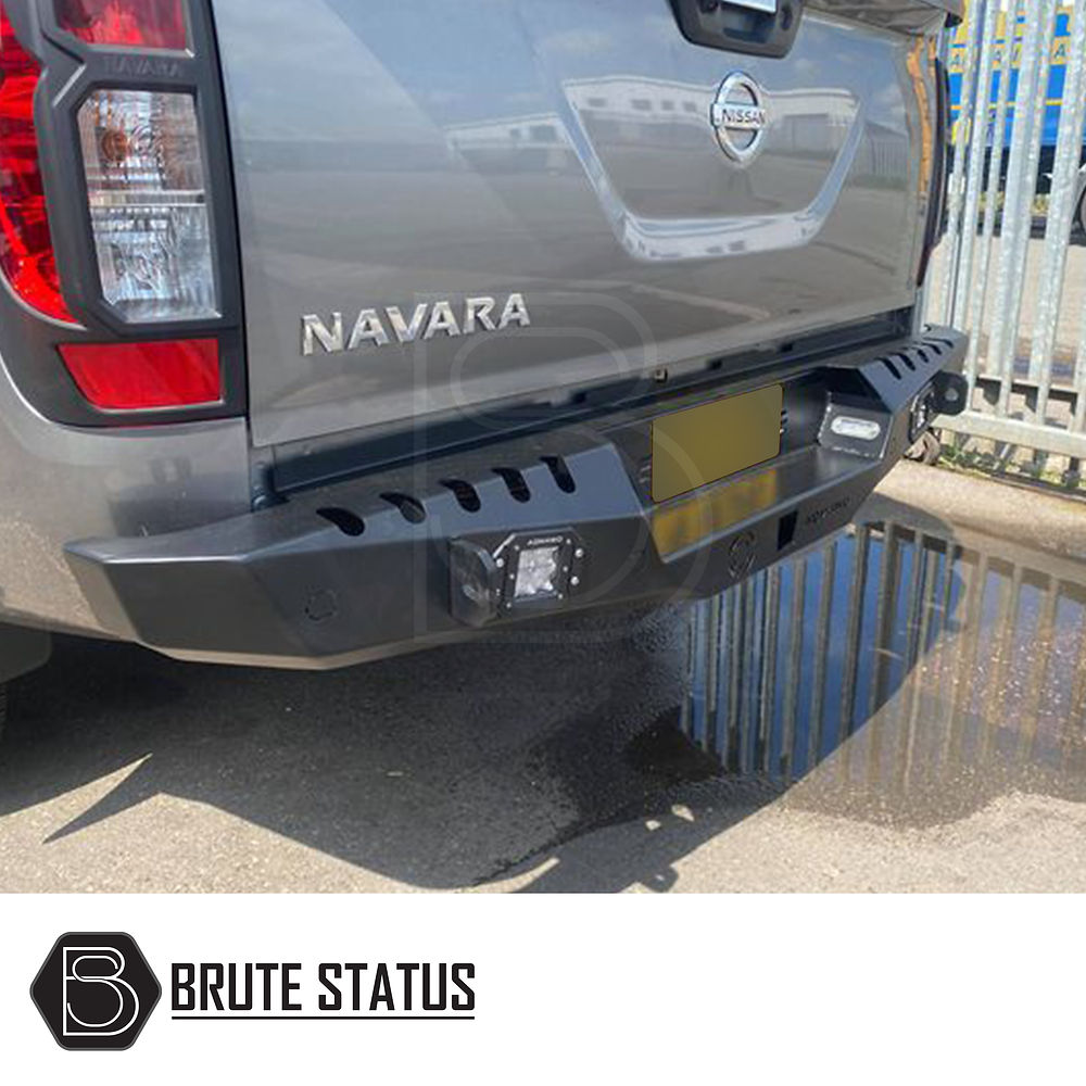 Nissan Navara D40 2010-2015 rear bumper in matt black, featuring parking sensor holes and lights, enhances style and protection.