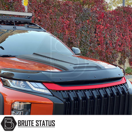 Mitsubishi L200 Series 6 2019+ Bonnet Scoop shown on a parked car, highlighting aggressive design and smooth black finish for enhanced truck aesthetics.