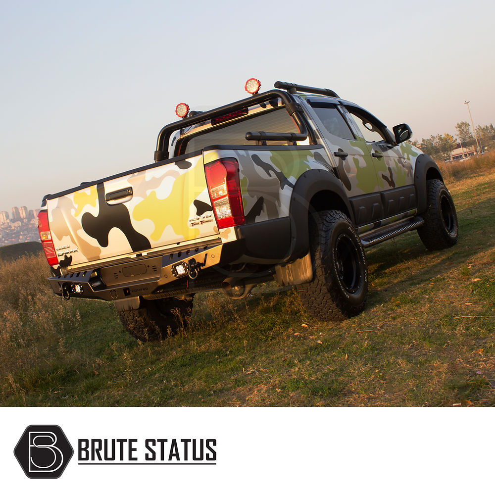 Isuzu D-Max 2012-2020 Rear Bumper Matt Black, enhancing style and impact resistance, featuring parking sensor knock-outs and lights, showcased on an off-road truck.