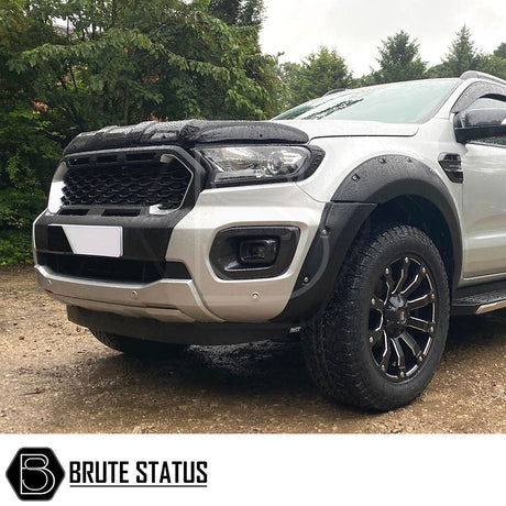 Ford Ranger 2019-2022 Wildtrak black grille with white LEDs, featuring a smooth finish and Raptor-inspired design, shown close-up on a parked car.