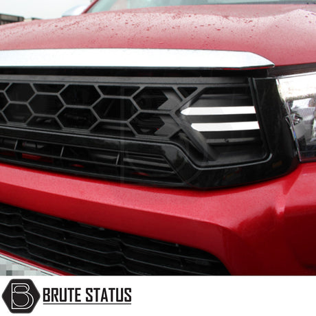 Toyota Hilux 2016-2020 Gloss Black DRL LED Grille featuring a sleek black design with bright LED lights, enhancing your vehicle's front aesthetic and functionality.