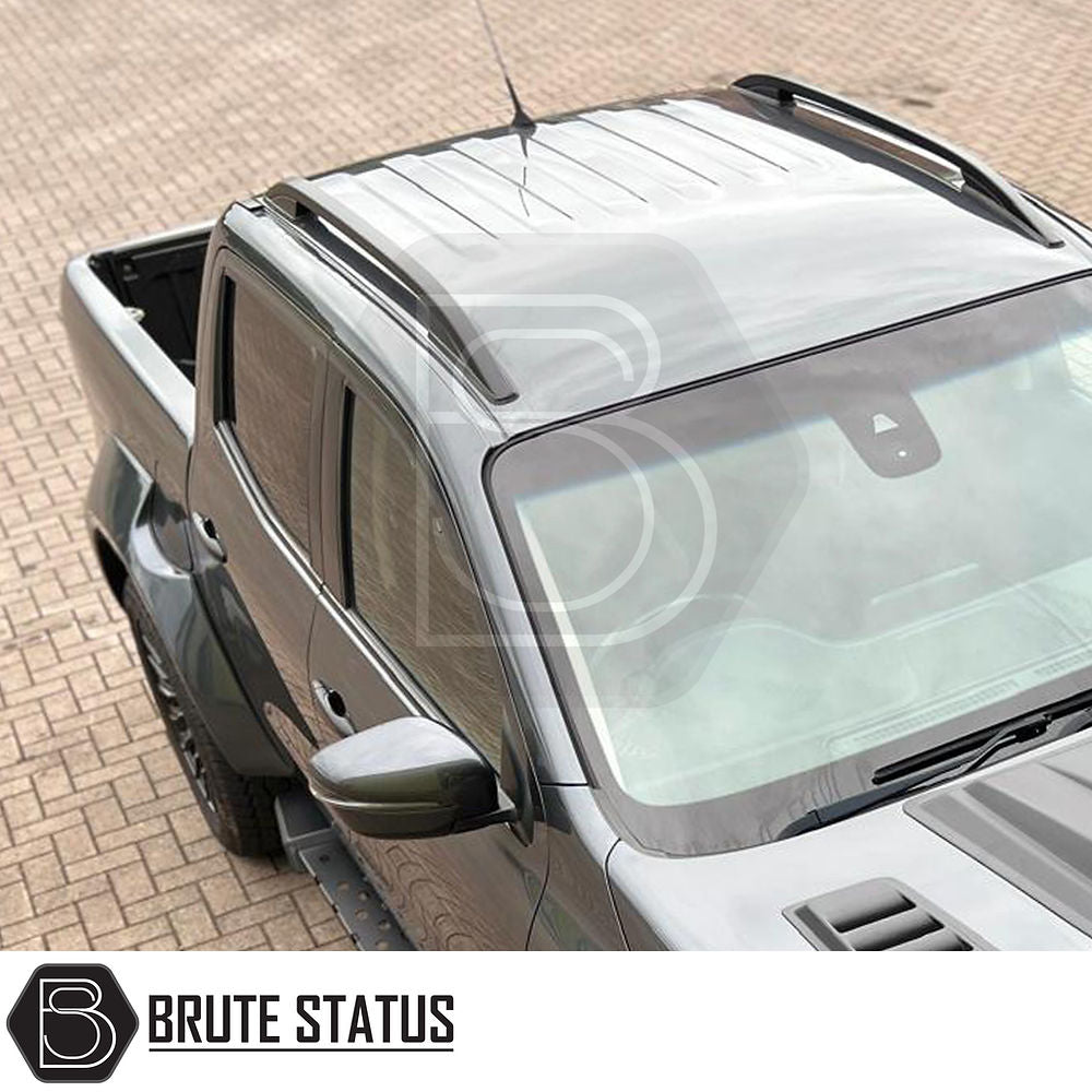 Nissan Navara NP300 2015-2022 Black Roof Rail Kit on a parked truck, designed for enhancing vehicle style and functionality.