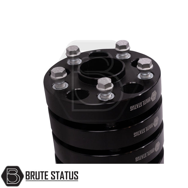 VW Amarok 2010-2022 30mm Hubcentric Wheel Spacers Set of 4, featuring black cylinders with silver bolts, enhancing vehicle stability and accommodating larger wheels.