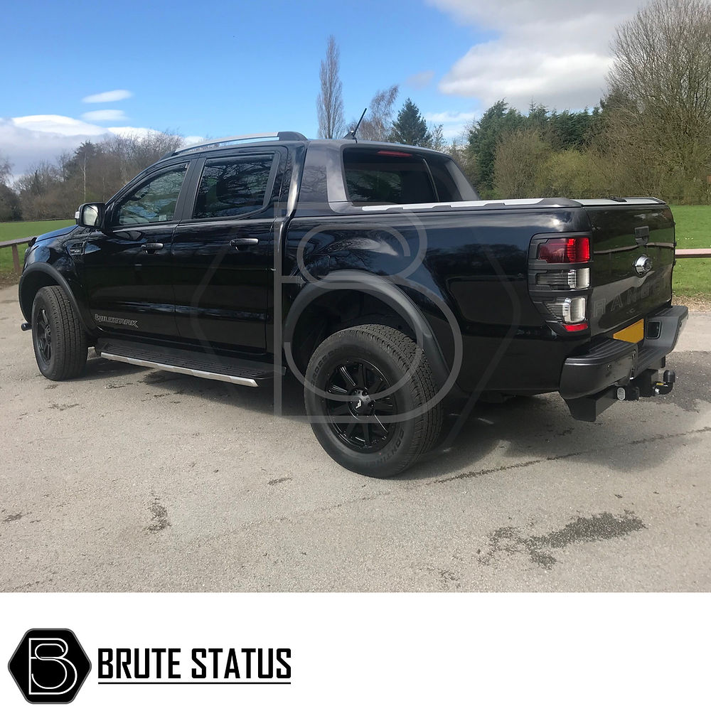 Ford Ranger 2012-2015 Wide Arch Kit - Slim Style, featuring sleek fender flares installed on a parked black truck, enhancing its rugged, customized appearance.