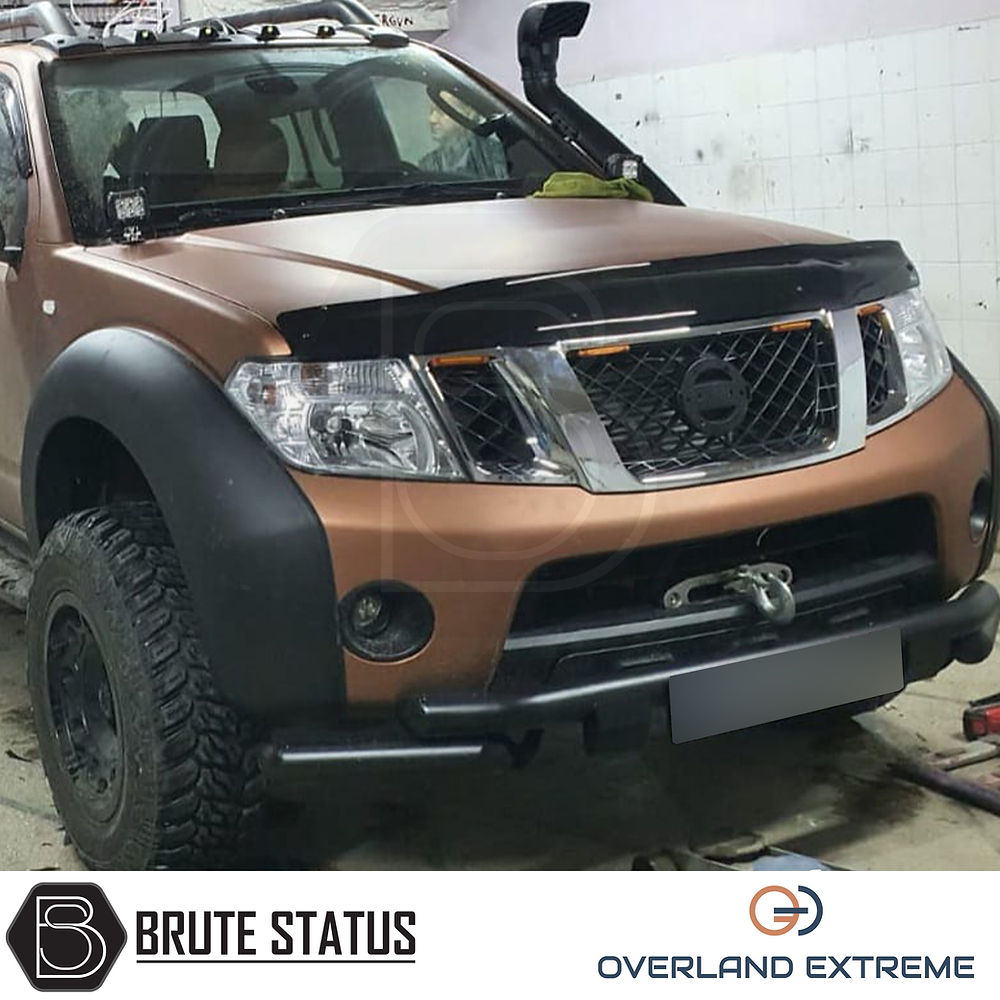 Nissan Navara D40 2010-2015 Overland Extreme Wide Arch Kit on a brown truck, showcasing precision-fit wheel arches and durable ABS plastic design.