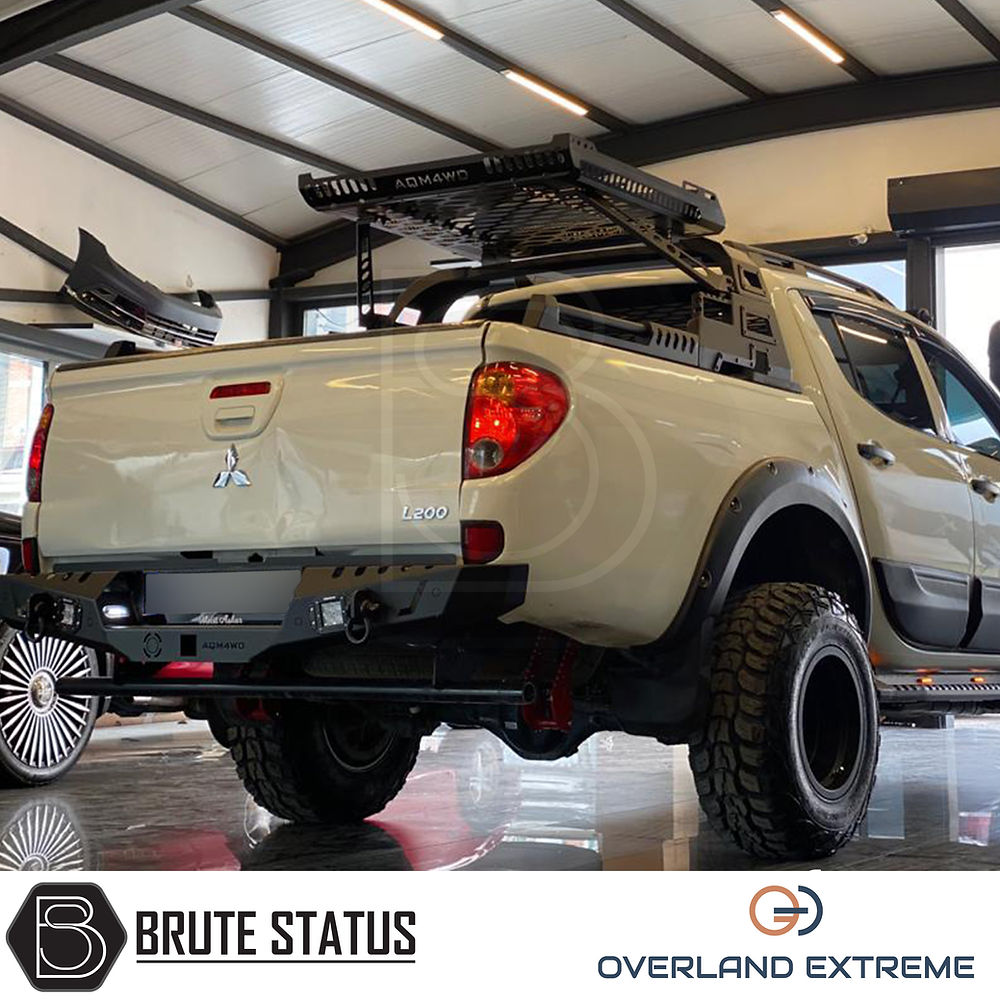 Mitsubishi L200 Series 4 2006-2009 Wide Arch Kit (Overland Extreme) in a garage, showcasing premium wheel arches designed for durability and style.