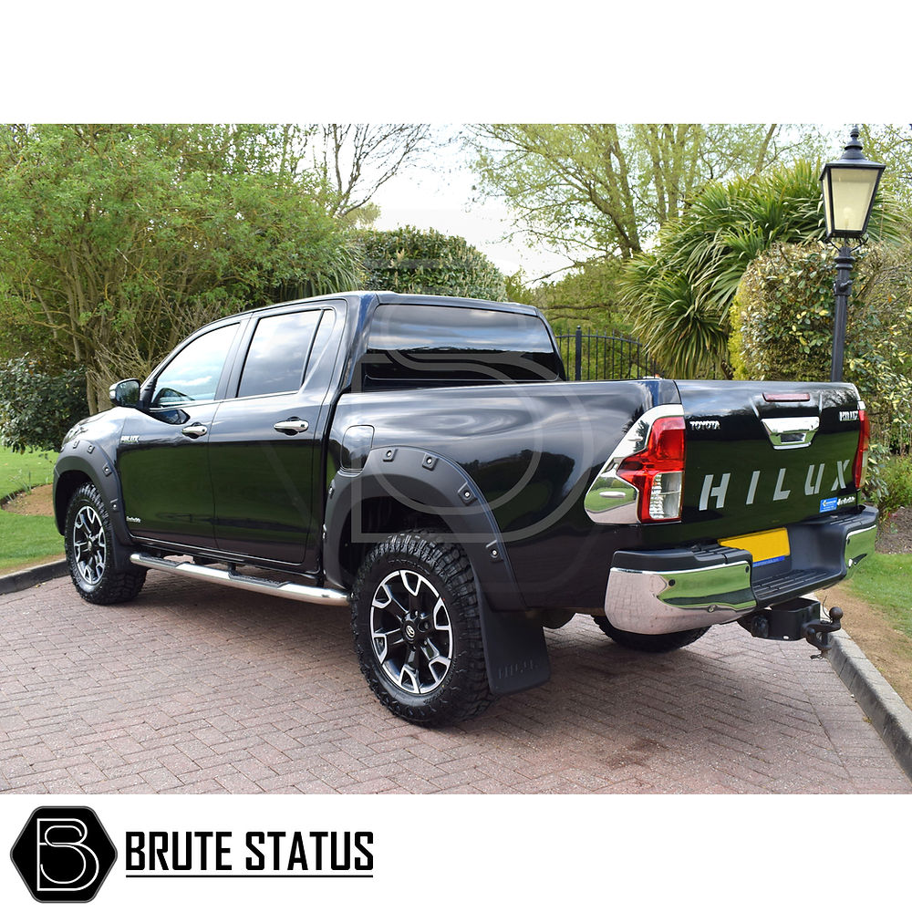 Toyota Hilux 2018-2020 Wheel Arch Kit (Riveted Style) on a black truck, showcasing its stylish, durable design and easy installation in a driveway setting.