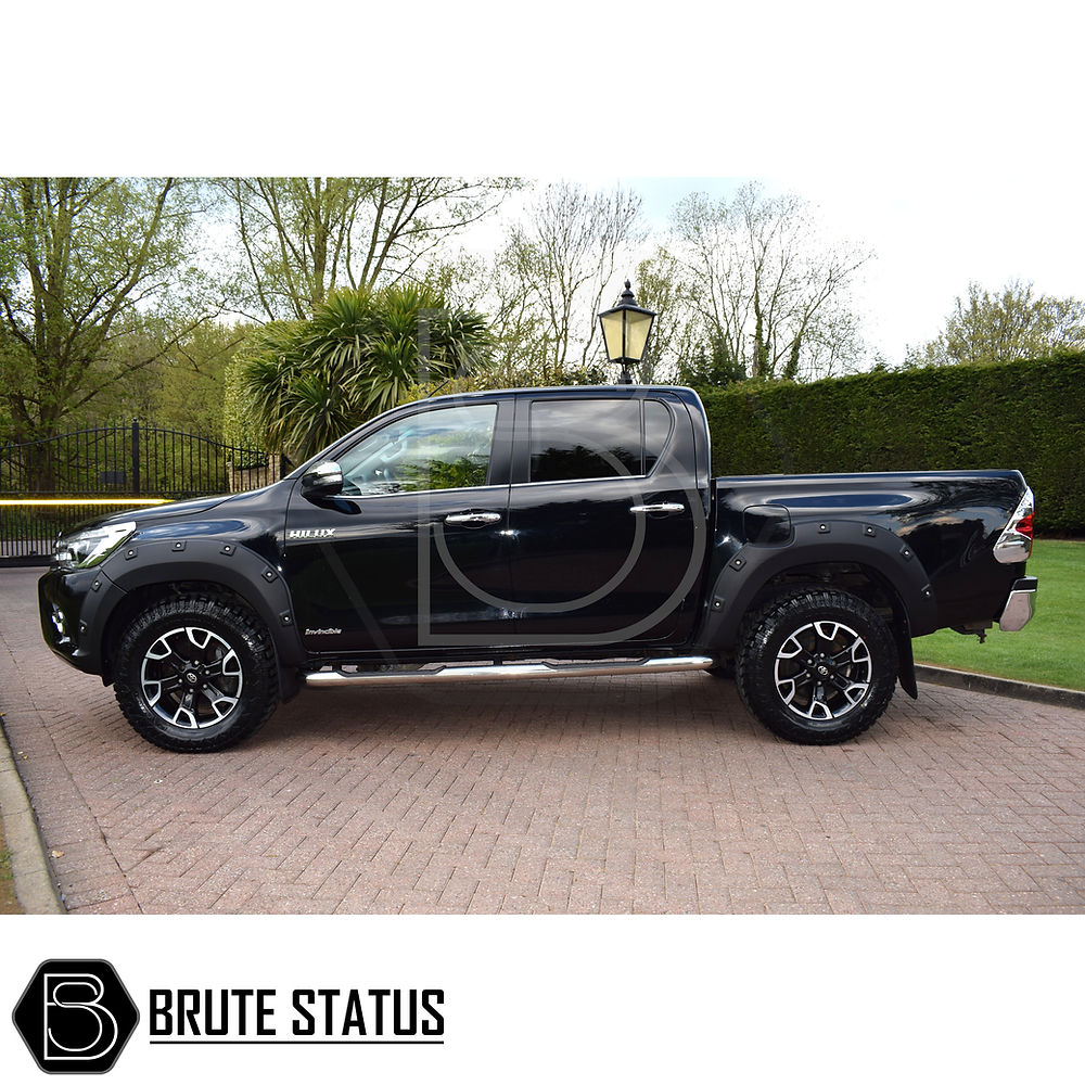 Toyota Hilux 2018-2020 Wheel Arch Kit (Riveted Style) displayed on a parked black truck, showcasing durable, stylish wide arches for enhanced aesthetic and protection.