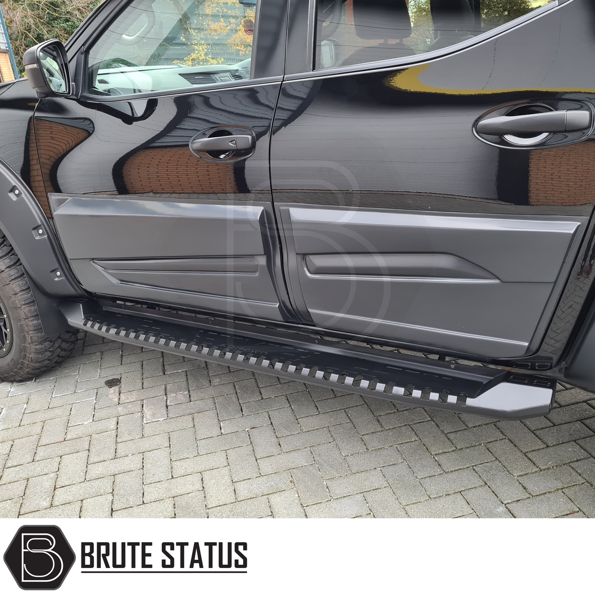 Mitsubishi L200 Series 4 2007-2014 Heavy Duty S30 Steel Side Steps in matt black, shown close-up on a black truck, emphasizing robust design.