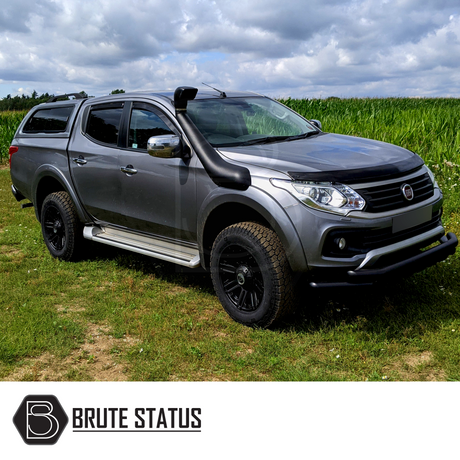 Fiat Fullback 2015-2019 Raised Air Intake Snorkel on a parked car in a field, highlighting its rugged design and compatibility with pick-up trucks.