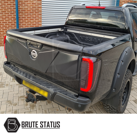 Nissan Navara NP300 2015-2022 Load Bed Rail Protector Set on a black truck, showcasing its durable ABS plastic design and easy installation features.