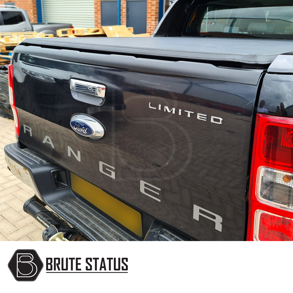 Tonneau Cover for Ford Ranger Wildtrak, tri-fold design, enhancing aerodynamics and load security, visible on the back of a black truck with logo details.