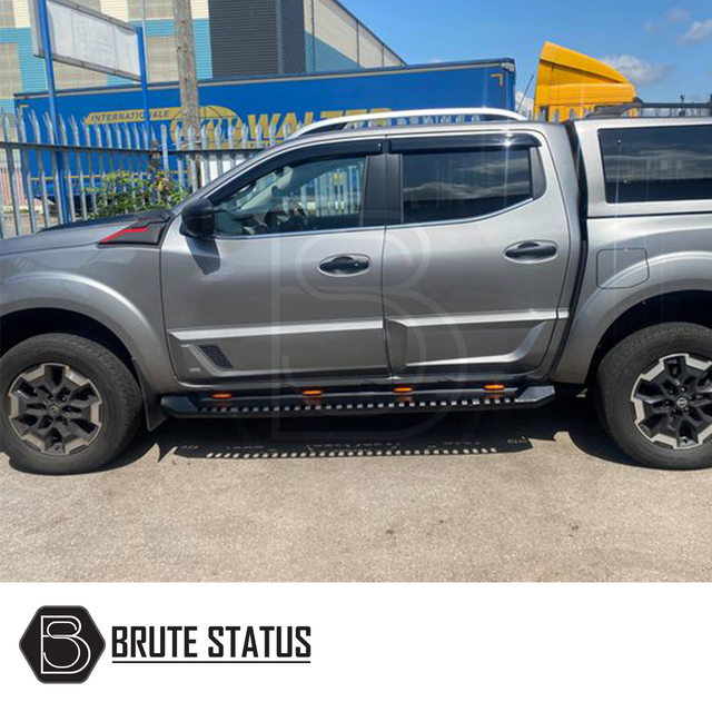 Nissan Navara NP300 2015-2022 Heavy Duty S30 Steel Side Steps with LEDs, shown on a grey truck in a parking lot, emphasizing durability and style.